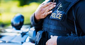 Close up photo of a police officer wearing a vest