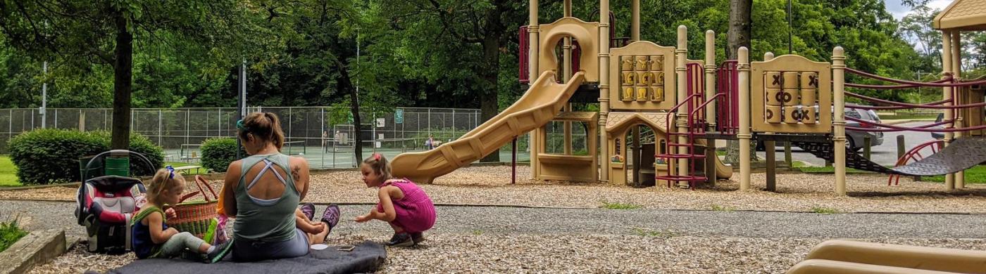 Family gathered in a playground in Catonsville Community Park.