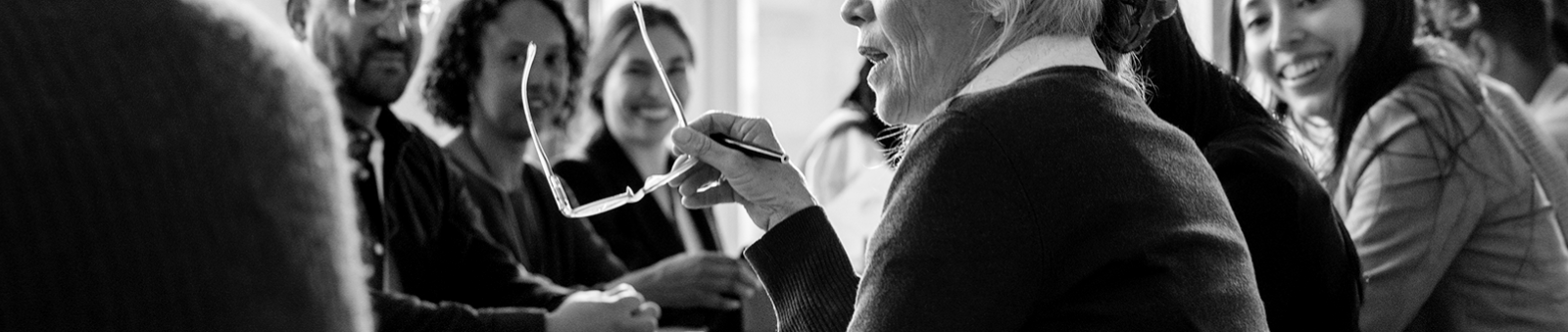 Photograph of a board room with people actively talking